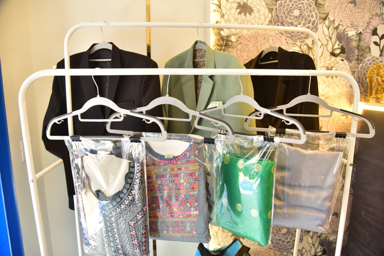 Freshly dry-cleaned garments packed on hangers